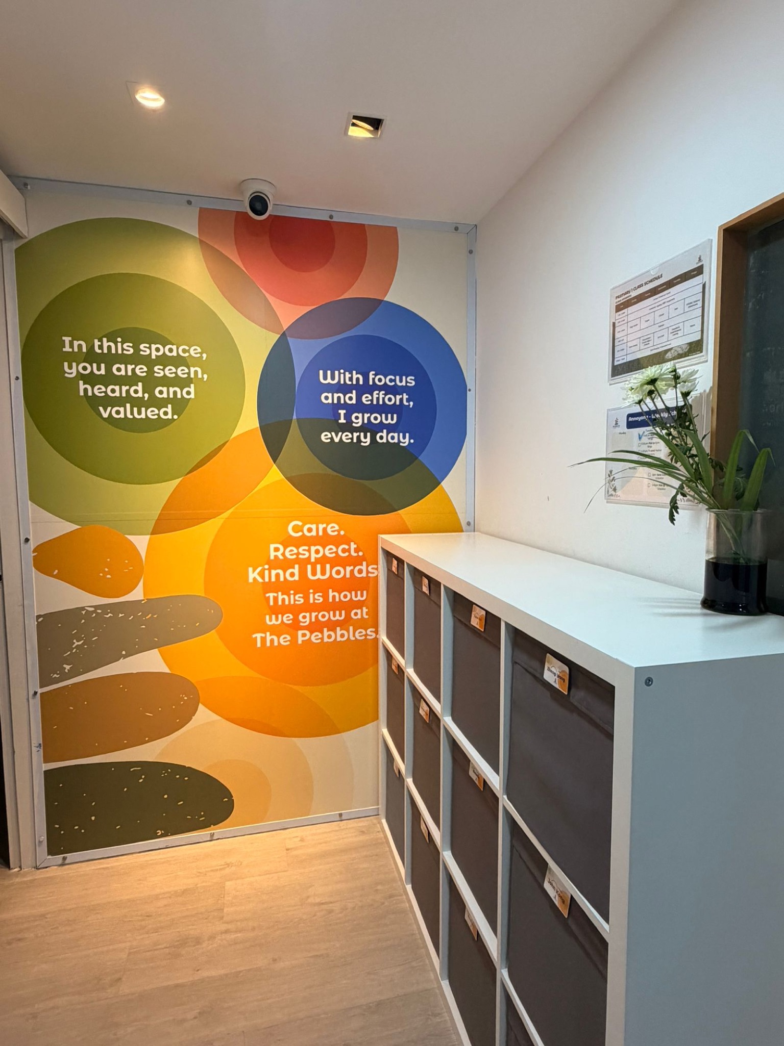 The Pebbles values wall — 'In this space you are seen, heard and valued. With focus and effort, I grow every day. Care. Respect. Kind Words.'